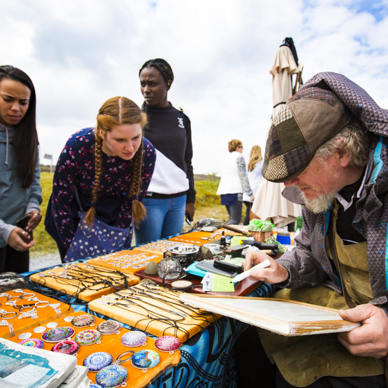 Champlain students on study abroad in Dublin. They are talking with a local artisan at his crafts booth. 