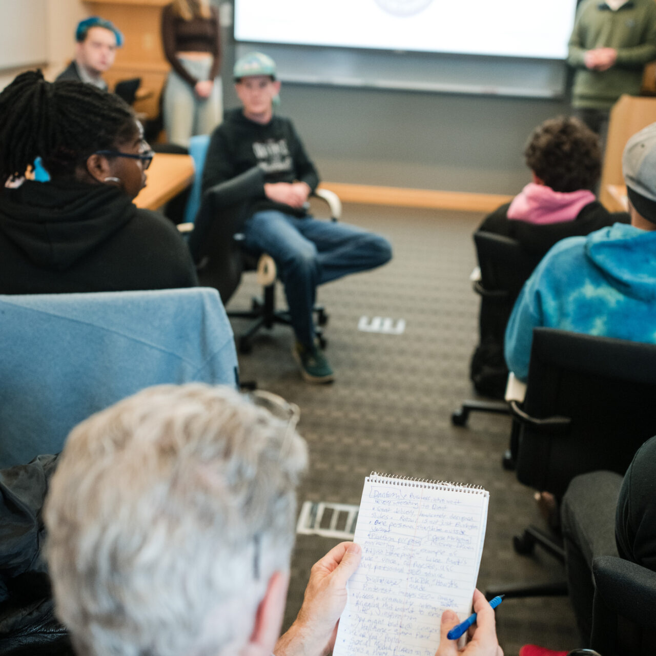 Professor studying notes during class